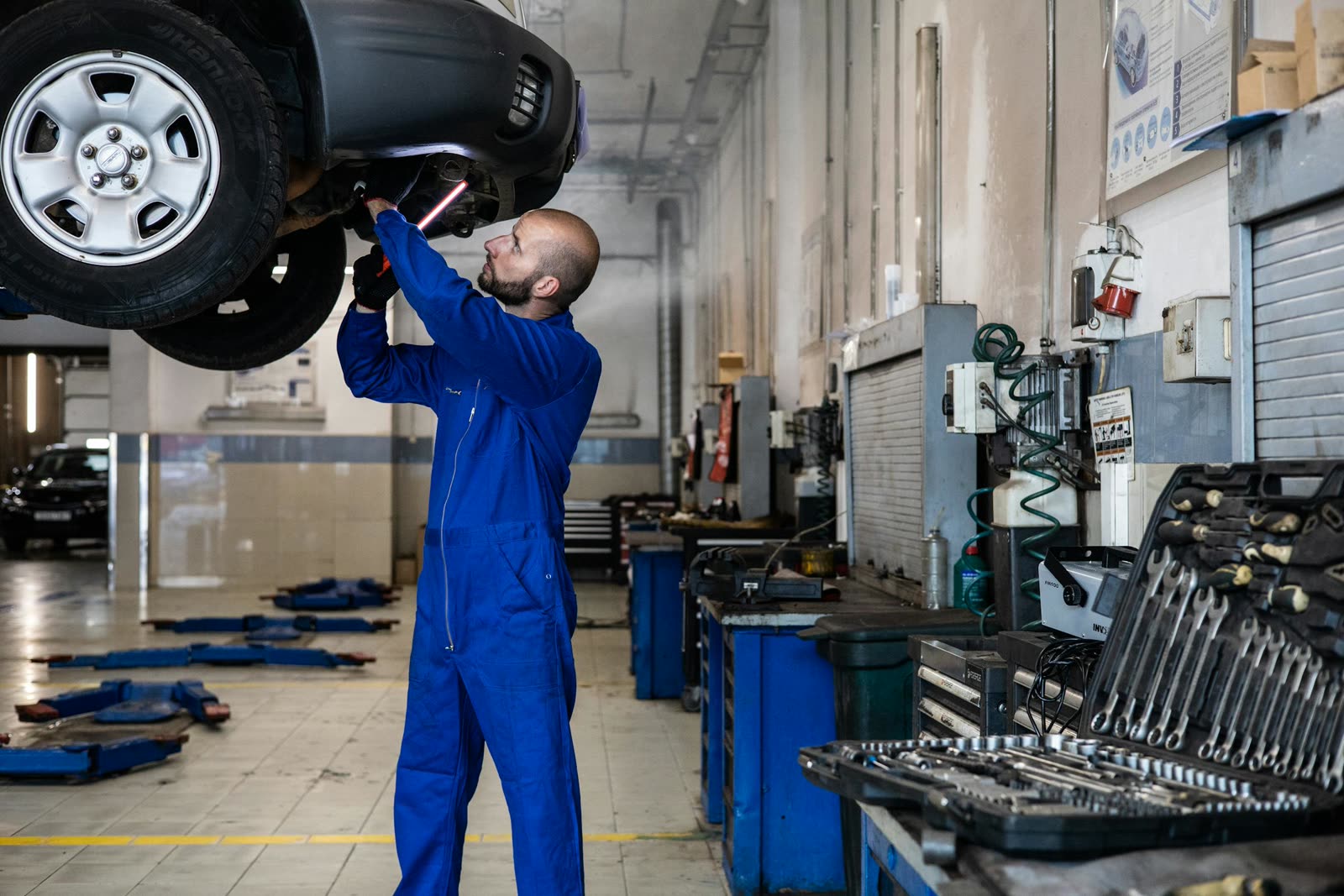 KFZ-Mechaniker bei der Arbeit am Fahrzeug